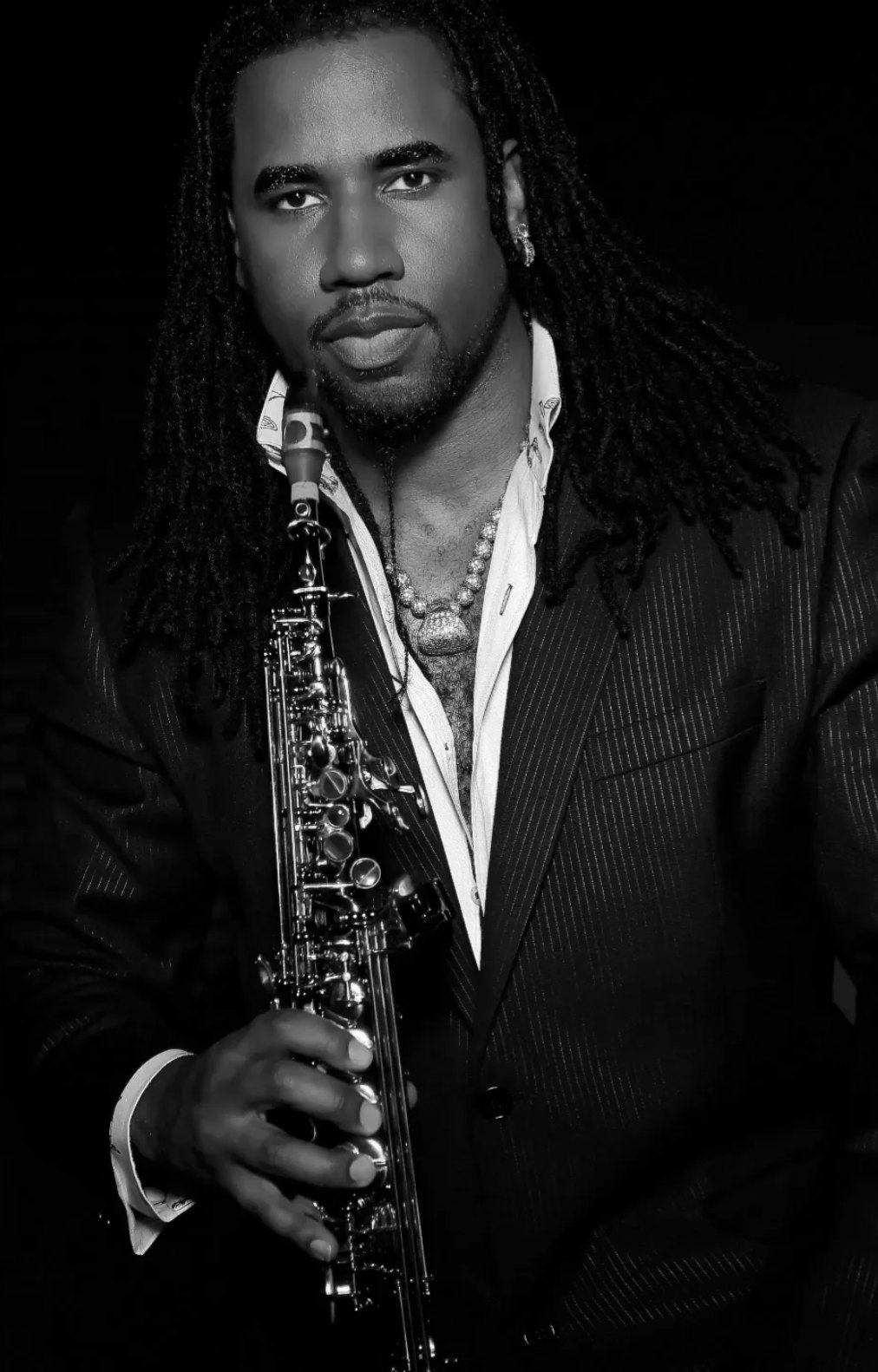 Lord Yancyy photographed in black and white with his saxophone